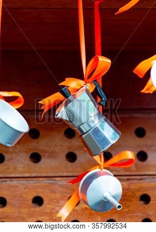 Christmas Decoration In Cafe, Traditional Italian Coffeemaker Macchinettas Hanging On Red Ribbons Ou