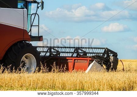 Cutter Platform At Work. Reaping Machine. Combine Harvester In The Field During The Harvest.