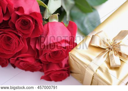 Gift Box For Valentine Day Tied With Golden Satin Ribbon Bow And Beautiful Roses. Nice Gifts For Wom