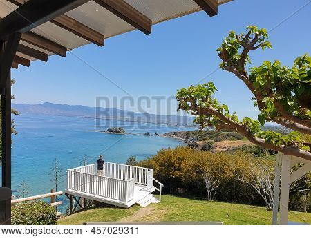 A Man Wearing A Hat Is Photographing The Scenic View Of A Beautiful Bay At Akamas Peninsula, Cyprus 