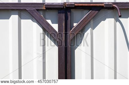 Latch On The Gate. Design For Locking The Gate From The Inside. Old Rusty Padlock On A Metal Fence. 