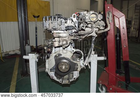 Rear View Of An Assembled Internal Combustion Engine Installed On An Engine Repair Stand In An Auto 