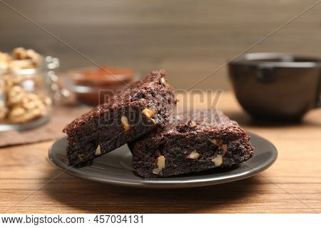 Delicious Chocolate Brownies With Nuts On Wooden Table, Closeup