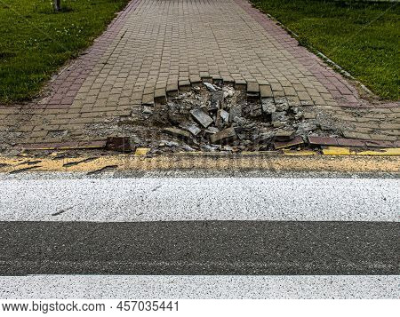 Bucha, Ukraine - June 20, 2022: Crater Funnel From A Snard Explosion At A Crosswalk, Sidewalk, Aspha