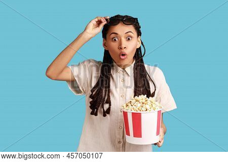 Excited Woman With Black Dreadlocks Holding Bucket Popcorn And Raising In 3d Glasses, Sees Shocked M
