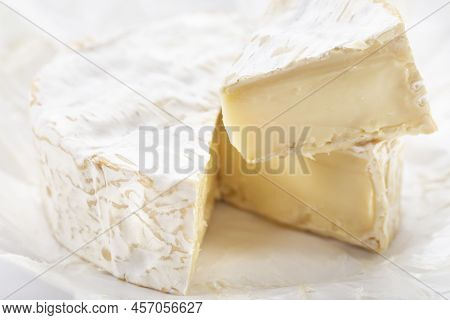 Brie Type Of Cheese. Close Up On Camember Cheese. Pieces Of Soft Cheese Reveal Its Runny Cream Textu