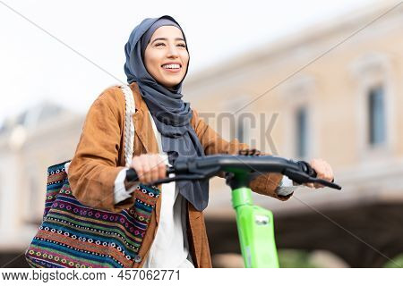 View Of A Muslim Woman Riding A Electric Scooter