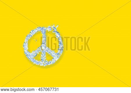 Peace Symbol Made Of Broken Glass Fragments On Yellow Background Of Ukrainian Flag Color, Close-up T