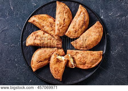 Fried Empanadas, Pastry Turnover With Hard Boiled Egg Fillings On Black Platter On Concrete Table, H