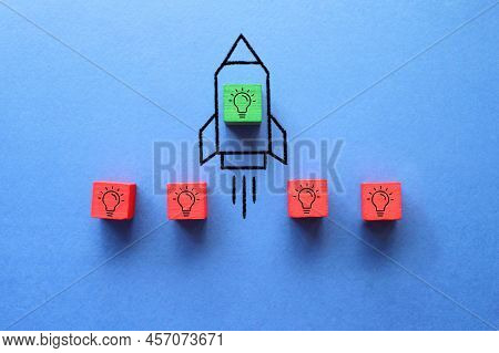 Cube With Idea Lightbulb Took Off On Rocket. Developing Startup, Best Idea. Business Accelerator.
