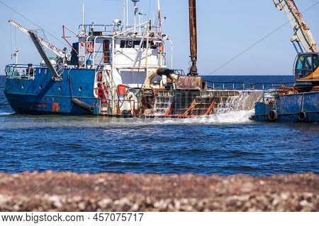 A Blue Ship Deepens A Port In The Blue Sea