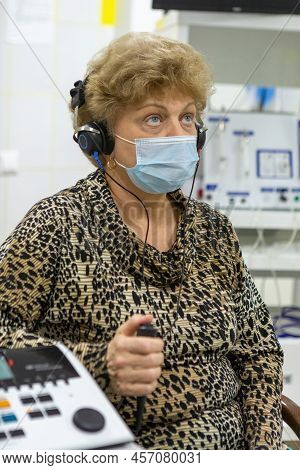 Audiologist Checks The Hearing Of An Older Woman
