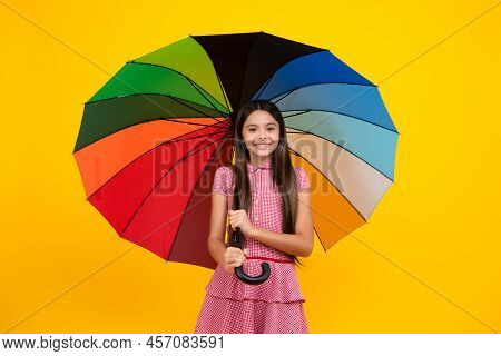 Summer Dress. Happy Teen Girl Holding Rainbow Umbella Standing Isolated On Yellow Background, Isolat