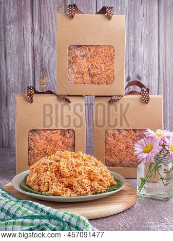 Sweet And Sour Crispy Noodles (or Mee Krob In The Thai Language) On A Dish With Cloth, Vase Placed O