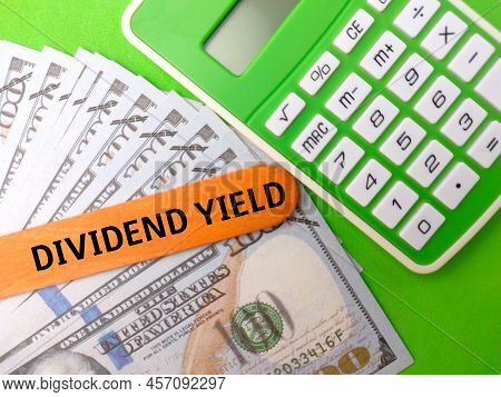 Calculator And Banknotes With The Word Dividend Yeild.