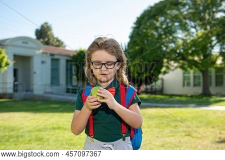 Schoolboy Eating Tasty Aplle Lunch Outdoors School.