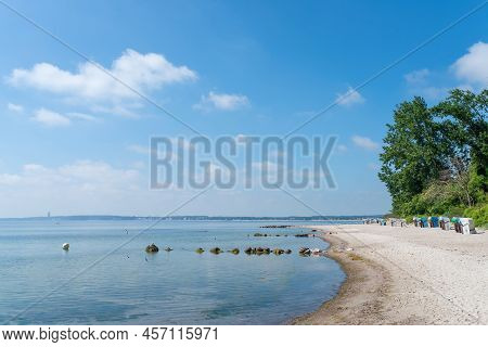 Traditional Beach Chairs On Baltic Sea Beach Against Blue Sky On Sunny Summer Day