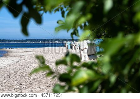 Traditional Beach Chairs On Baltic Sea Beach Against Blue Sky On Sunny Summer Day