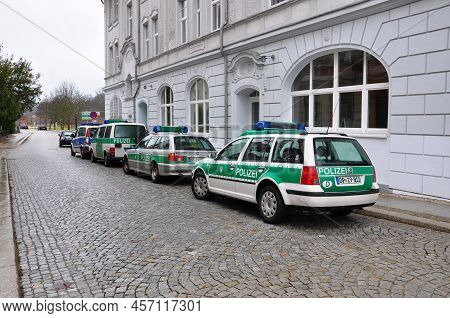 Guben, Germany - January 5, 2013: Police Patrol Cars Parked Along City Street Road At Building Exter