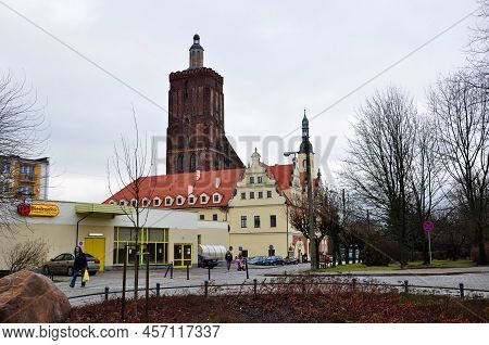 Gubin, Poland - January 5, 2013: Street View On Biedronka Supermarket And Town Hall Building With Ch