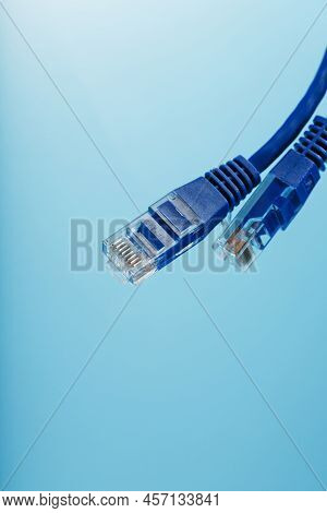Ethernet Cable Connector Patch Cord Cord Close-up On A Blue Background With Free Space