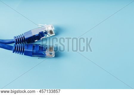 Two Ethernet Cable Connectors Patch Cord Cord Close-up Isolated On A Blue Background With Free Space