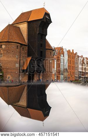 Ancient Crane - Zuraw Old Town In Gdansk. The Riverside On Granary Island Reflection In Moltawa Rive