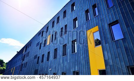 Fragment Of Modern Urban Geometry. Walls  Office Building Made Of Steel And Glass. Bright Sunny Day 