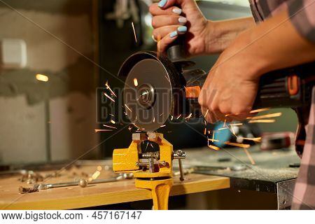 Woman Locksmith Works With Grinder Machine, Fly Bright Sparks