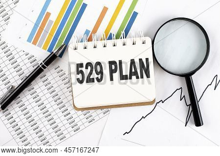 529 Plan Text On Notebook On Graph Background With Pen And Magnifier