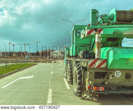 Boom Type Crane, Truck Crane At The Construction Site Of A New Microdistrict, Heavy Vehicles Marked 