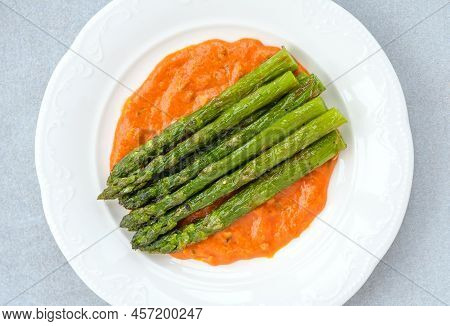 Fried Asparagus With Romesco Sauce On White Plate