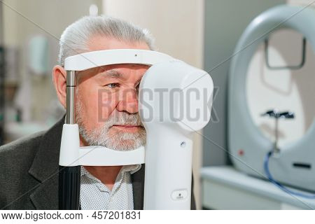 Examination Of Elderly Man On Corneo Topographer.modern Clinic