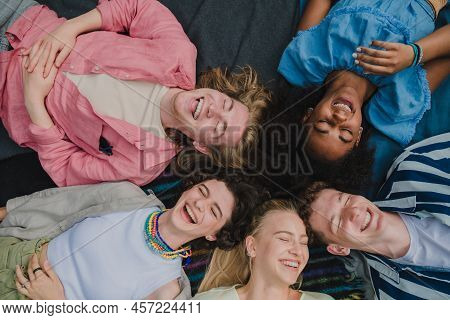 Top View Of Diverse Group Of Friends Having Fun Together At Park Lauging And Lying On Ground, Friend