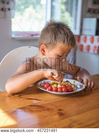 Blond Child In Domestic Kitchen Eat Healthy Food, Organic Vegan Fritatta  With Vegetables.