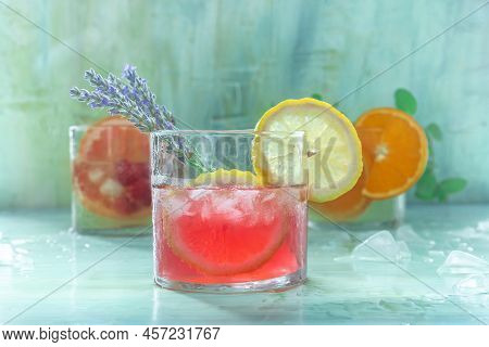 Summer Cocktails Or Mocktails, Cold Drinks With Ice, Fruit And Lavender, Party Lemonade On A Blue Ba