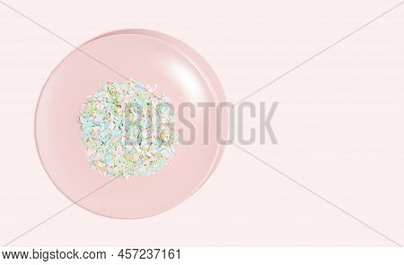 A Plate Full Of Microplastics On A Pink Background. Impact Of Micro Plastic In Food Chain. The Conce