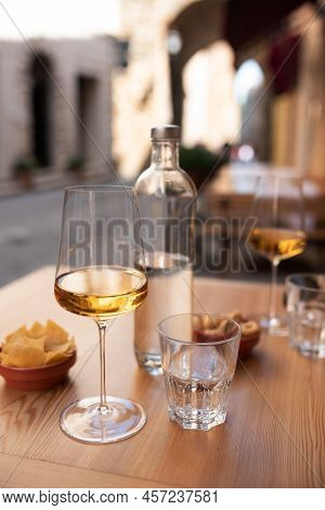 White Wine And Water Outdoors In An Mediterranean Old Town. Vertical Holiday Background With Short D