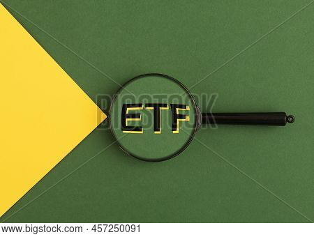 Etf Analysis Concept. Word Through Magnifying Glass. High Quality Photo
