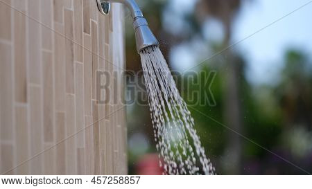 Detail Of Outdoor Water Shower On Beach. Water Pouring From The Shower On The Street Concept