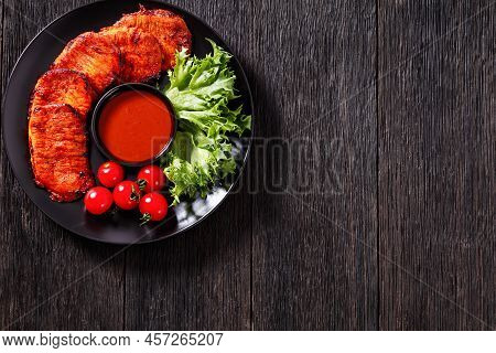 Grilled Slices Of Pork Loin Marinated In Paprika Based Sauce With Fresh Tomatoes And Lettuce Leaves 
