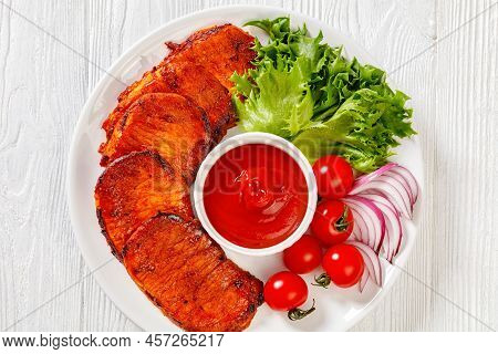 Grilled Slices Of Pork Loin Marinated In Paprika Based Sauce With Tomatoes And Lettuce, Red Onion On