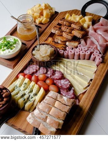 Delicious Charcuterie Board With Snacks Cheese, Toast, Ham, Blue Cheese, Almonds, Caramelized Onions