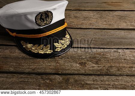 Peaked Cap With Accessories On Wooden Background, Space For Text