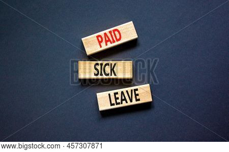 Paid Sick Leave Symbol. Concept Words Paid Sick Leave On Wooden Blocks. Beautiful Black Table Black 