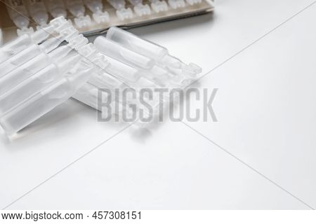 Single Dose Ampoules Of Sterile Isotonic Sea Water Solution On White Background. Space For Text