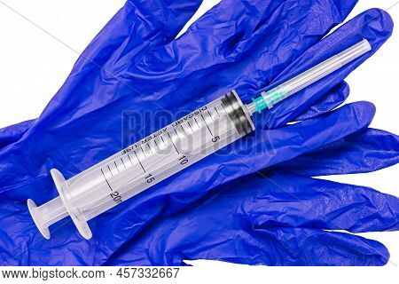 Medical Syringe On Blue Sterile Gloves. Used Medical Syringe.