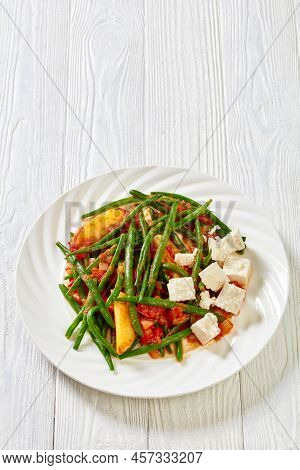 Fasolakia Lathera, Green Beans, Onion And Potatoes Braised In Tomato, Herbs And Olive Oil On White P