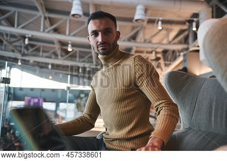 Portrait Of A Handsome Multi-ethnic Young Man, Passenger In Casual Pullover Relaxing In The Vip Loun