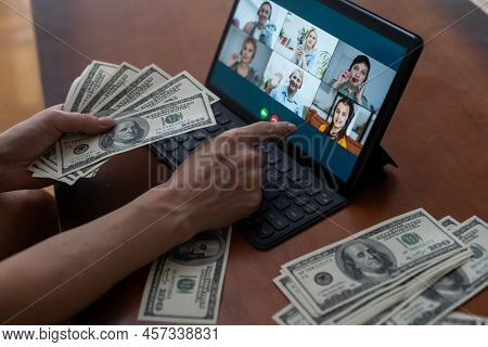 Tablet Screen And Lot Of Hundred Dollar Bills. Business And Social Networking Concept